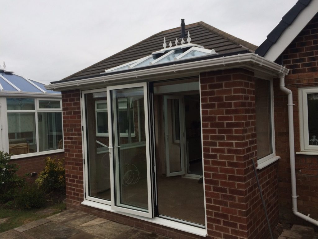 White orangery with 3 pane bifold doors